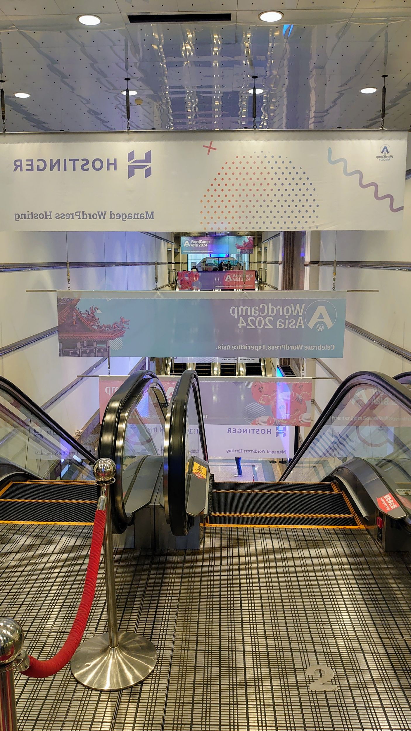 Hanning banners on escalators - The see-through effect viewed from 2F